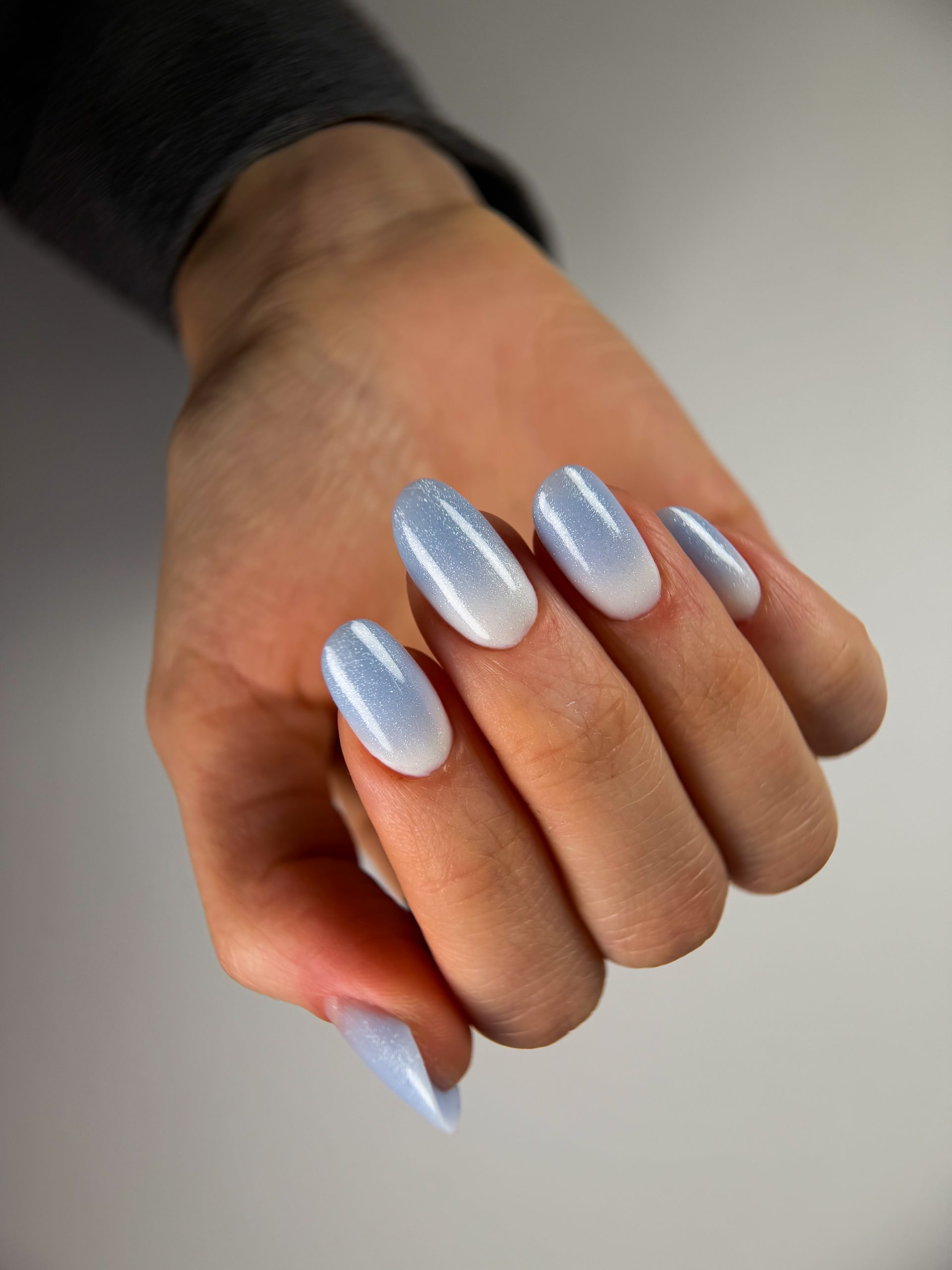 Close-up of beautifully styled nail extensions, featuring elongated, well-shaped nails with a polished and elegant finish.