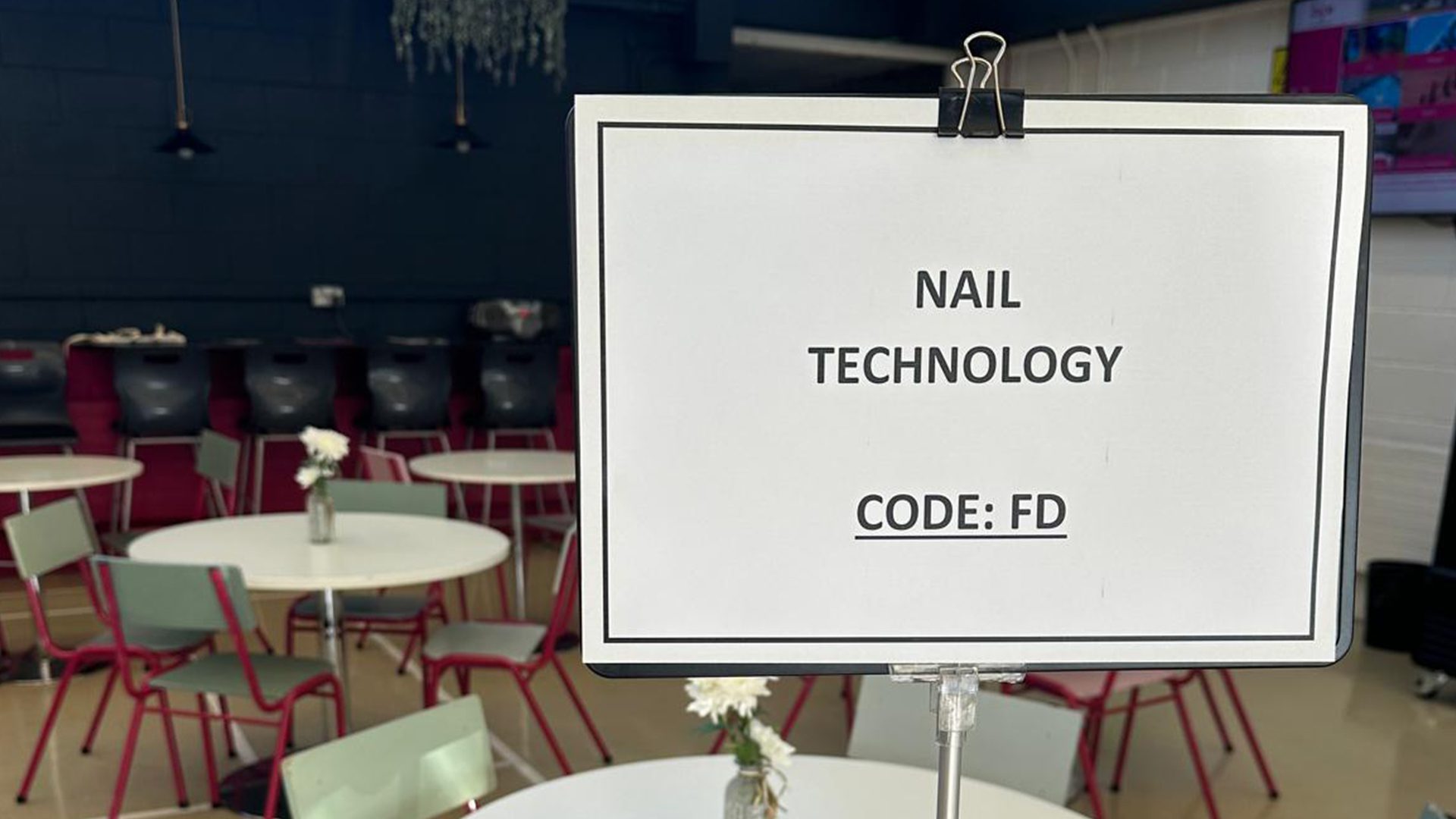Nail technician managing salon administration tasks in a professional beauty salon environment.