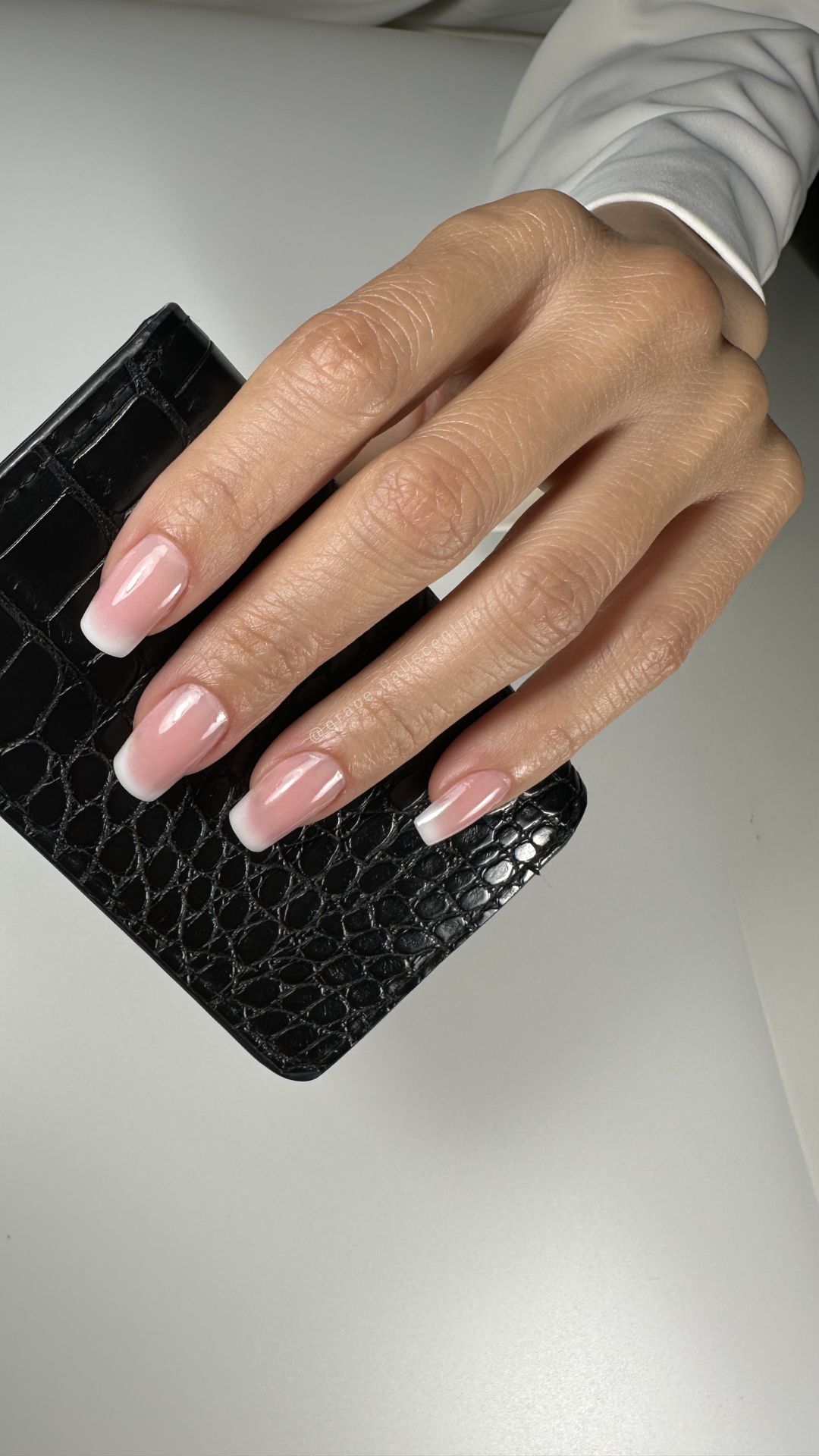Nail extensions with a soft French design and natural, elegant finish.