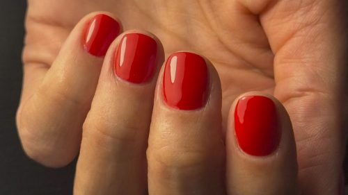 Bright and glossy red gel polish manicure with a strong, high-shine finish.