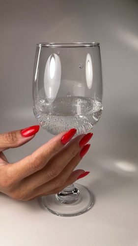 Nail extensions finished with bright red gel polish and a strong, high-shine glossy finish.