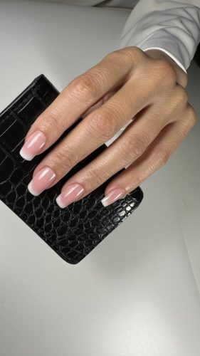 Nail extensions with a soft French design and natural, elegant finish.